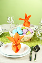 Easter table setting on color background