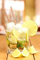 Glass of cocktail with lime and mint