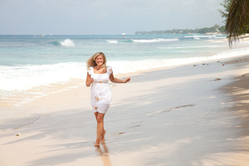 happy girl running on the beach