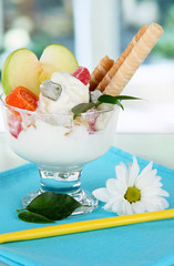 Ice cream with wafer sticks on blue napkin on window background