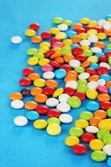 Colorful candies on blue background