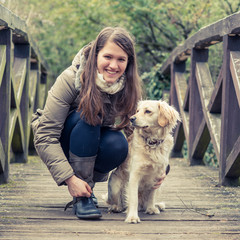 A girl relaxing outside with her dog.