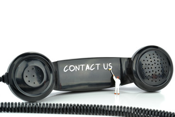Contact us being painted on a telephone handset