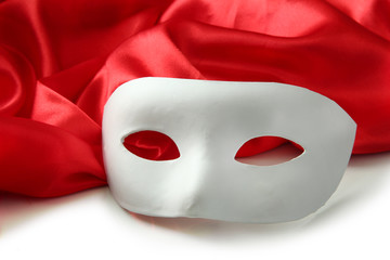 White mask and red silk fabric, isolated on white