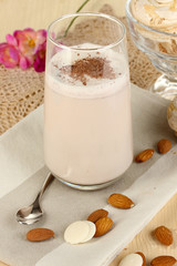 Glass of chocolate-cream cocktail on wooden table close-up