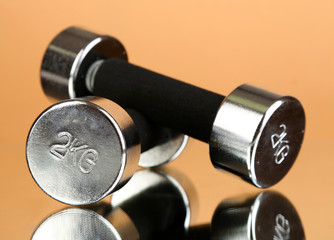 Dumbbells at 2 kg on beige background