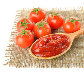 Tomato sauce and ripe tomatoes on white background