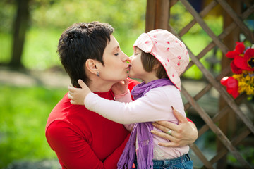mother and daughter kissing