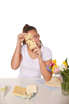 Young woman peeping through a cheese