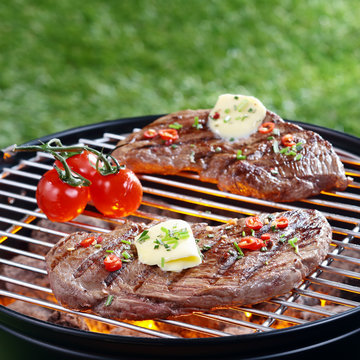 Delicious steak grilling on a barbecue