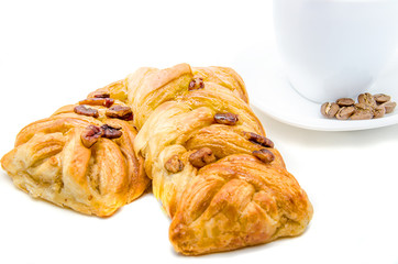 Two pastries filled by honey syrup and sprinkled by pecan nuts