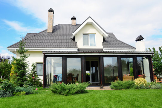 A new house with a garden in a rural area under beautiful sky