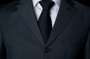 Dark business suit with a tie