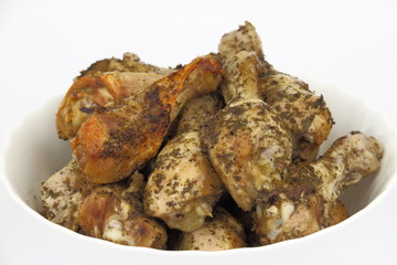 Roasted chicken legs in the white dish