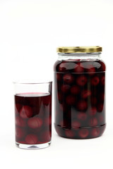 Compote with cherries in jar and glass
