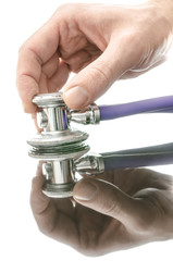 Doctor holding a stethoscope on a surface with reflection
