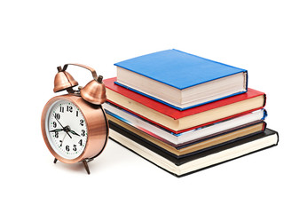 clock and books on a white background