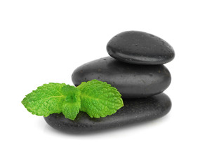 Fresh mint on the black stones with drops