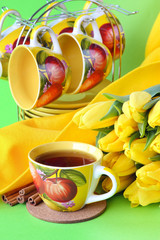 Tea cups and yellow tulips