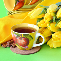 Tea cups and yellow tulips