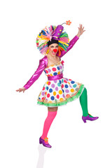Funny girl clown with a big colorful wig dancing