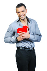 Beautiful handsome young macho man holding love heart and smilin