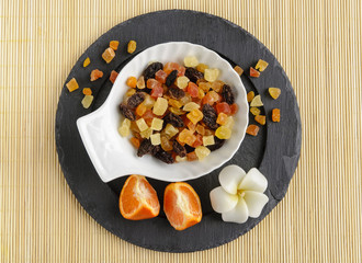Dried fruits on stone plate with flower