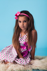 Obraz na płótnie Canvas cute little girl on blue background