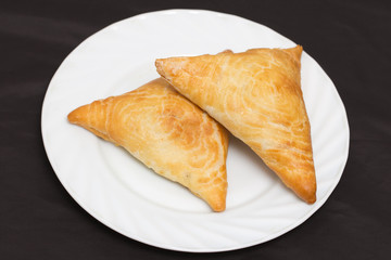 Uzbek samosa on a black background