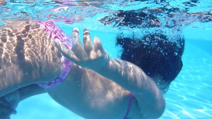 cute girl playing in the pool