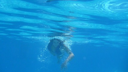cute girl playing in the pool