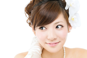 Fototapeta premium Beautiful asian woman dressed as a bride on white background