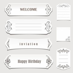 Vintage white paper banners with calligraphic elements.