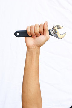 The strong hand hold the adjustable wrench