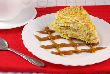 Cake Napoleon with sour cream on a plate