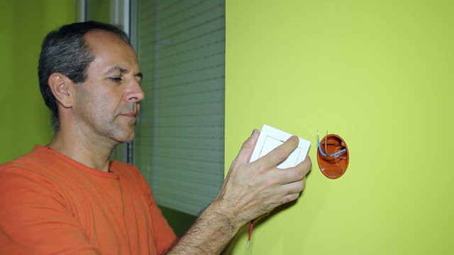 Electrician Installing Switch on the Wall