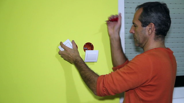 Man Installing an Electrival Switch