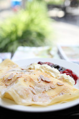 crape cake with berry sauce