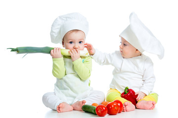 babies boy and girl wearing a chef hat with healthy  food vegeta