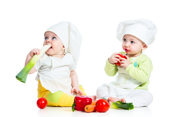 babies boy and girl wearing a chef hat with healthy  food vegeta