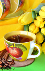 Tea cups and yellow tulips