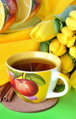 Tea cups and yellow tulips