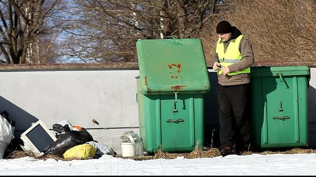 Worker collects waste in containers