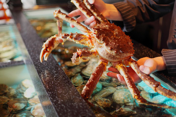 living marine crab in hand restaurateur