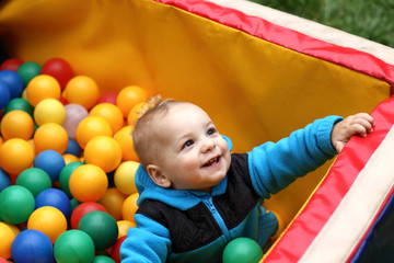 Fototapeta na wymiar Toddler in box of balls