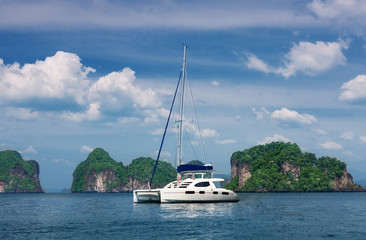 white catamaran to stand against rocks. Thailand