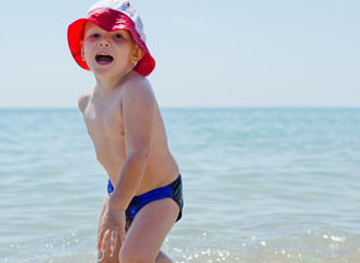 Cute little boy romping in the sea