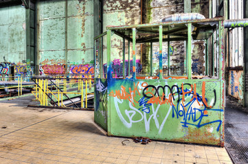Derelict tagged booth in an bandoned power plant