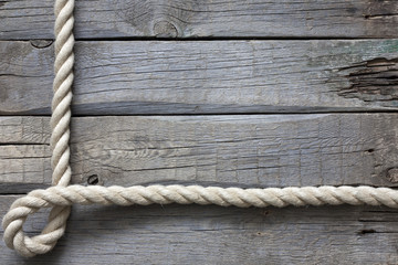 Rope on old vintage wooden planks abstract background