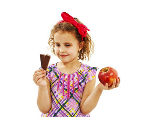 Healthy diet choices - little girl with apple and chocolate